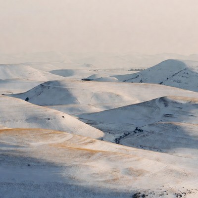 Snow-covered hills in winter morning light