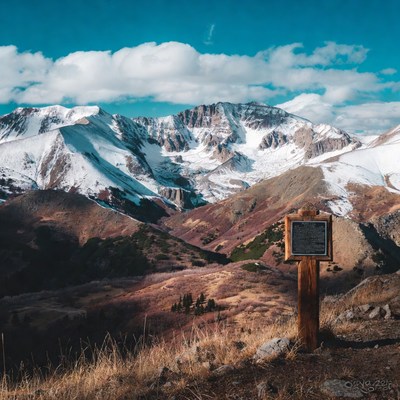 Mountains under blue sky with sign