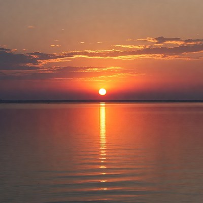 Sunset over calm water landscape