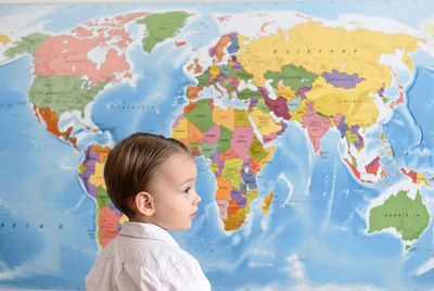 Child looks at world map