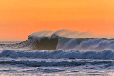 Waves rolling in at sunset