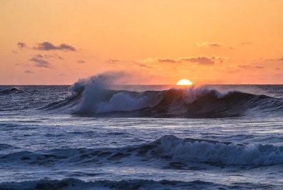 Sunset over ocean waves at the beach