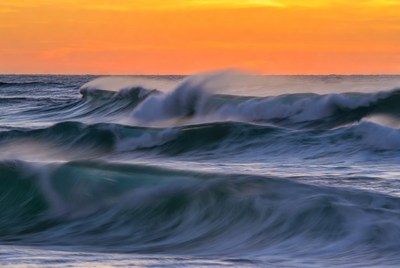Waves rolling at sunset