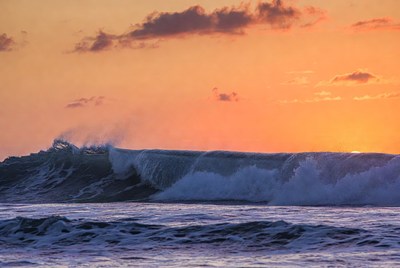 Waves crashing at sunset