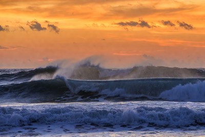 Waves crashing at sunset on the coast