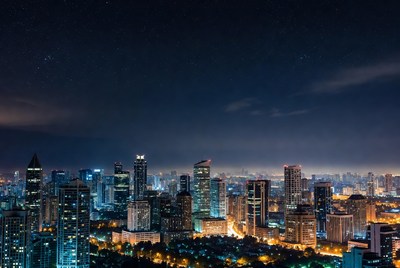 City skyline at night with stars