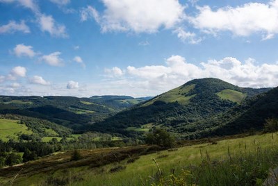 Green hills under a blue sky
