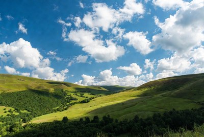 Green hills under blue sky