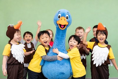 Kids with a large blue goose character
