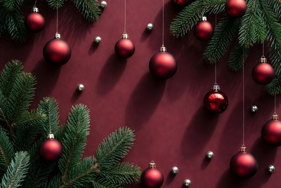 Festive red ornaments on green branches