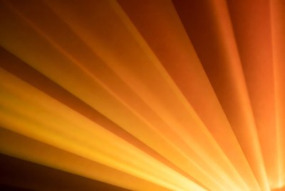 Light beams shine through darkness