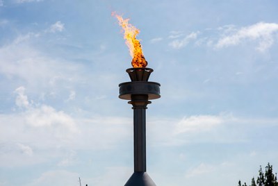 Torch burns brightly against blue sky