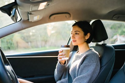 Woman drinking coffee in car