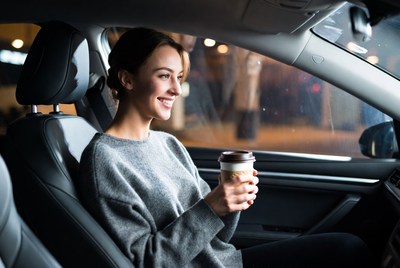 Enjoying coffee in a car