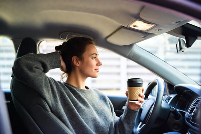 Woman enjoying coffee in car