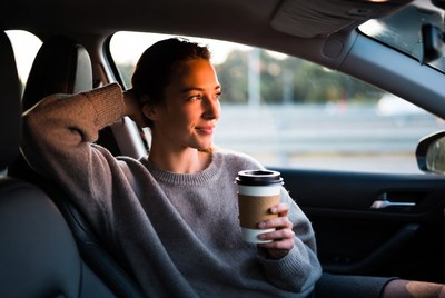 Woman enjoying coffee in car