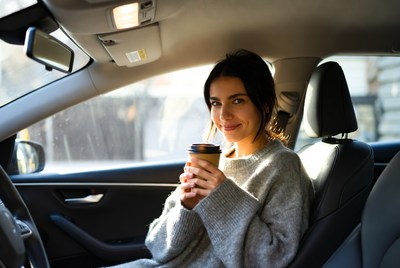 Woman enjoying coffee in car