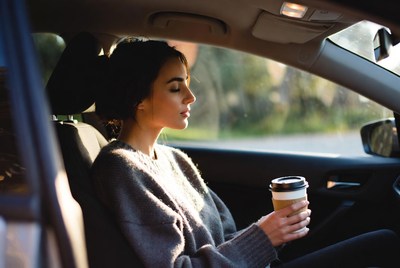 Woman enjoying coffee in car