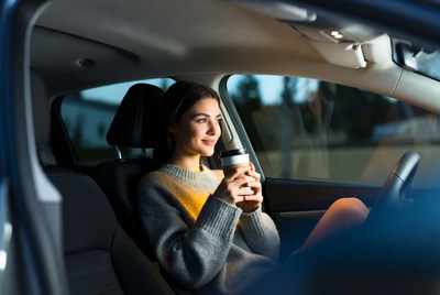Woman enjoying coffee in car