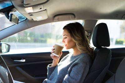 Woman drinking coffee in car