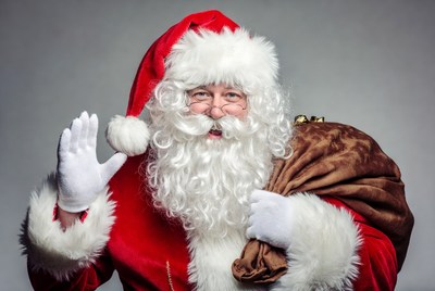 Santa claus waving with a bag