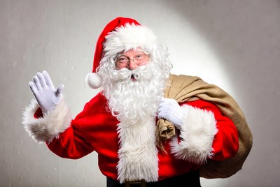 Santa waving with bag of gifts