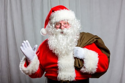 Santa claus smiles and waves happily