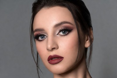 Model with makeup on gray background