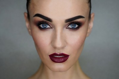 Woman with bold makeup and dark lips