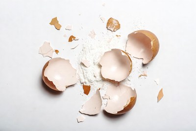 Broken eggshells on white surface