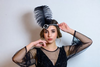 Woman in black dress with feather accessory