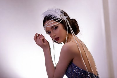 Model poses in a stylish dress with pearls