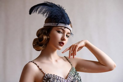 Woman in vintage dress with feathers