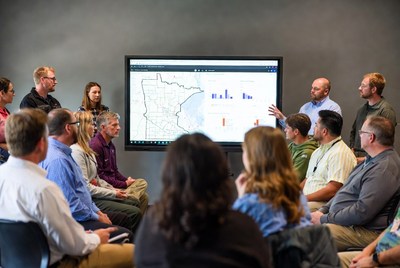 Group discusses data in meeting room