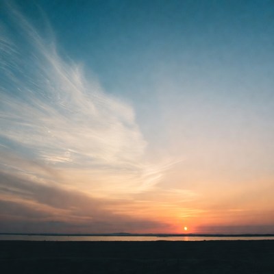 Sunset over the water at dusk