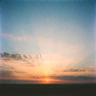 Sunset over open field in rural area