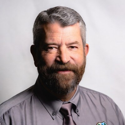 Man with beard in gray shirt