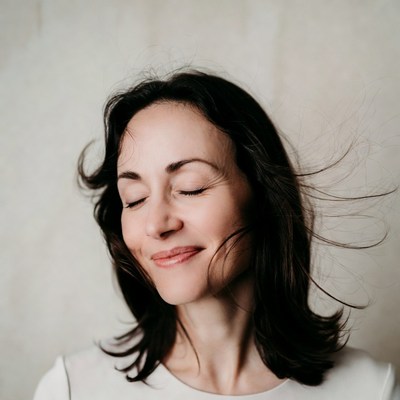 Woman smiling with eyes closed