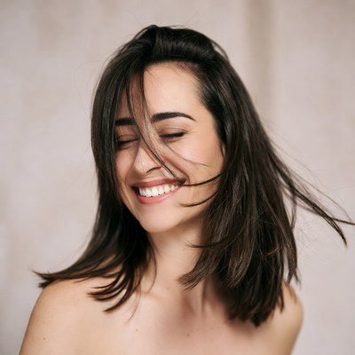 Woman smiling with hair blowing