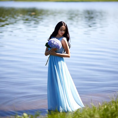 Young woman with flowers in water