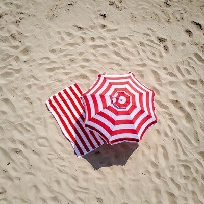 Beach umbrella and towel on sand