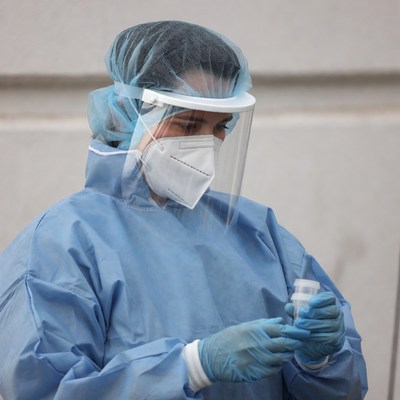 Medic prepares for testing in protective gear