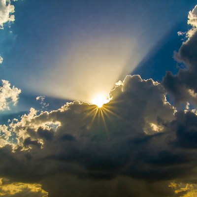 Bright sun emerging from clouds