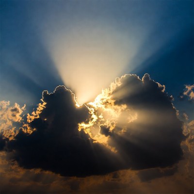 Rays of light shine through clouds