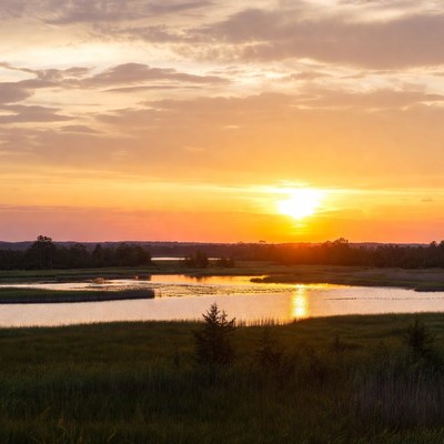 Sunset over still water in a rural area