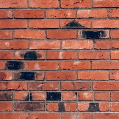 Brick wall with black marks