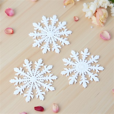 White snowflakes on wooden surface