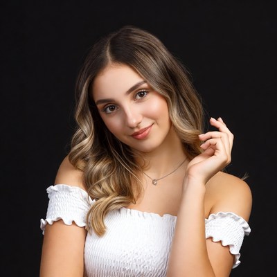 Young woman poses with soft smile