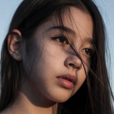 Girl with long hair against blue sky