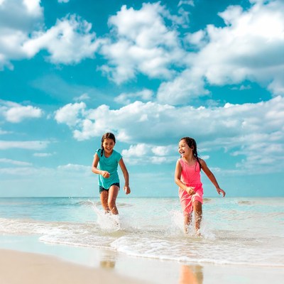 Girls play and splash at the beach